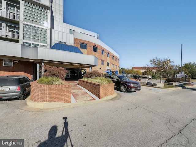 view of building exterior with uncovered parking