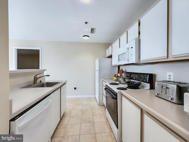 kitchen featuring light countertops, visible vents, a sink, white appliances, and white cabinetry