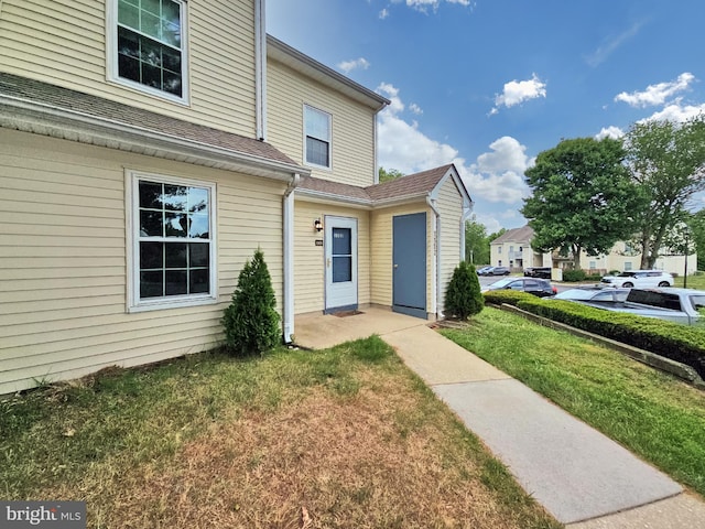 property entrance with a yard