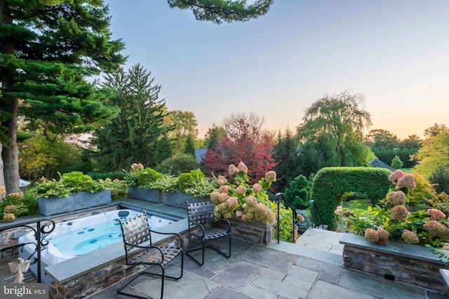 patio terrace at dusk with an outdoor hot tub