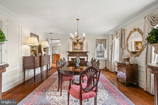 dining room featuring a chandelier, crown molding, and dark wood-type flooring