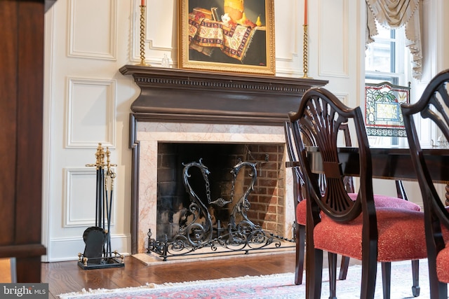 details featuring wood-type flooring and a premium fireplace