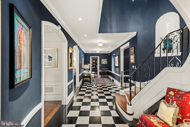 entryway featuring crown molding and decorative columns