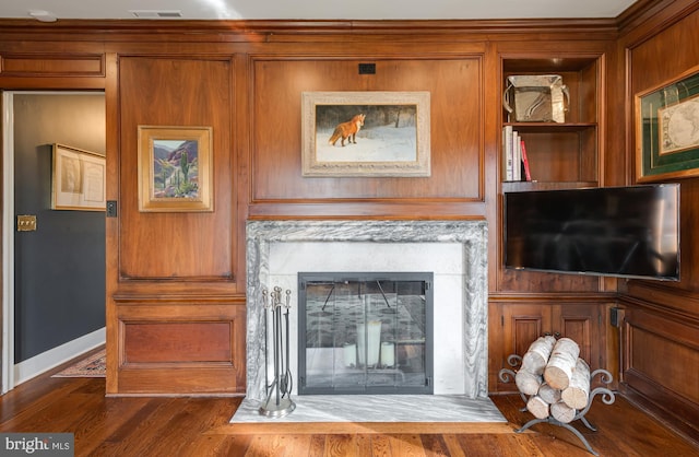 unfurnished living room featuring a fireplace and dark wood-type flooring