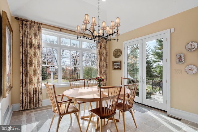 dining room featuring french doors and a chandelier