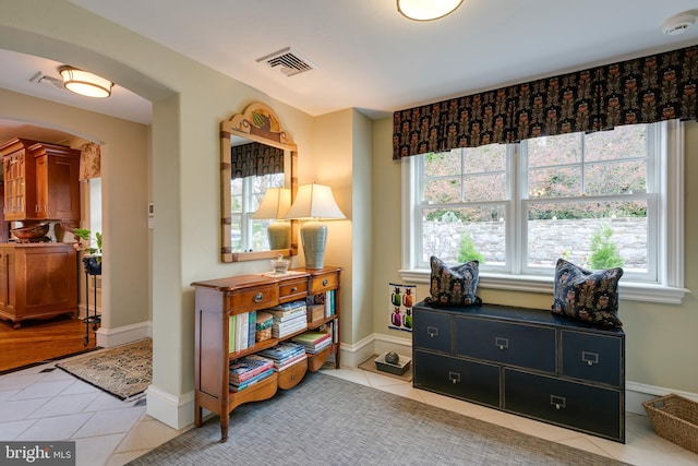 sitting room featuring light tile patterned flooring and plenty of natural light