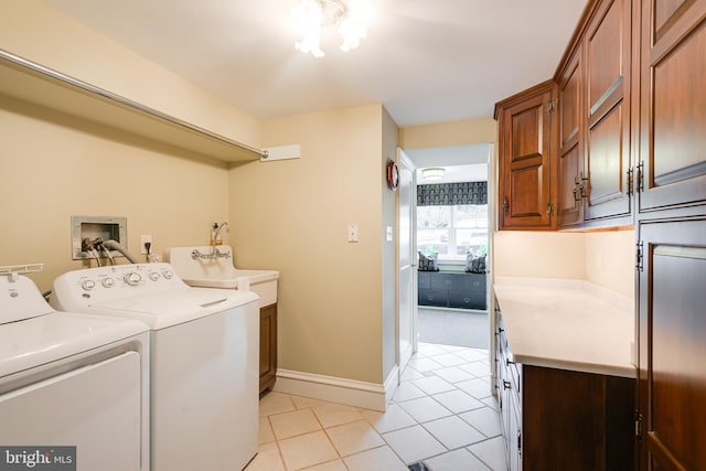 laundry area featuring cabinets, washing machine and dryer, and light tile patterned floors