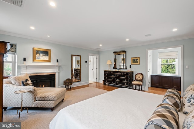 bedroom with light hardwood / wood-style floors and crown molding