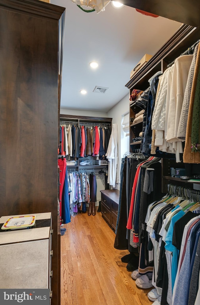 spacious closet featuring light hardwood / wood-style floors