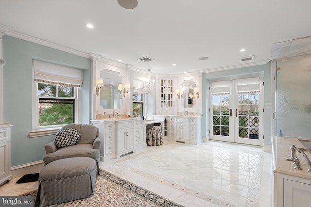 bathroom featuring french doors, crown molding, and a healthy amount of sunlight