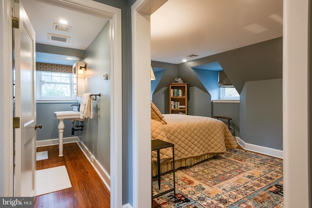 bedroom with dark hardwood / wood-style floors