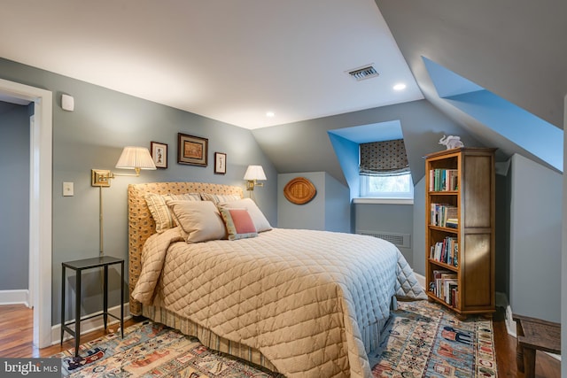 bedroom featuring wood-type flooring and vaulted ceiling