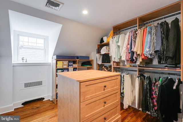 spacious closet featuring light hardwood / wood-style flooring