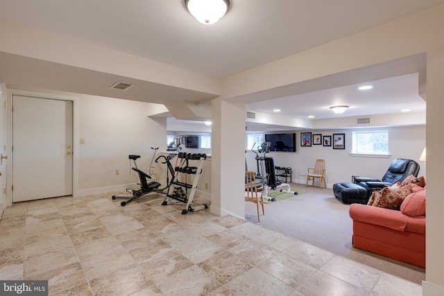 exercise room featuring light carpet