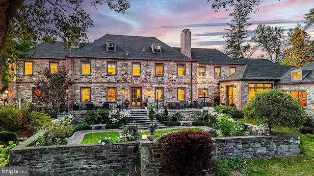 view of back house at dusk