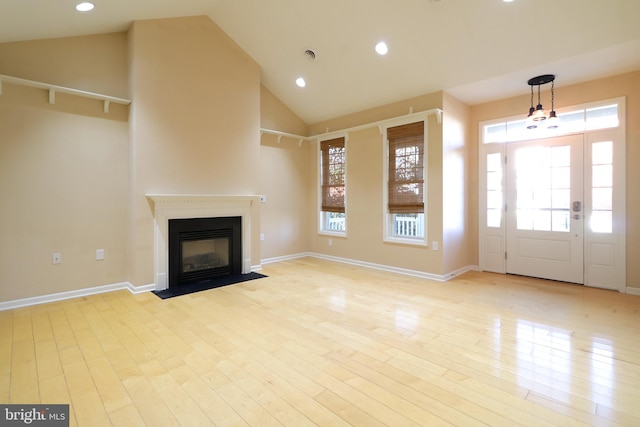 unfurnished living room with lofted ceiling and light hardwood / wood-style flooring