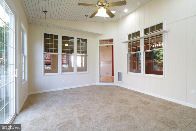 unfurnished sunroom with ceiling fan, lofted ceiling, and wooden ceiling