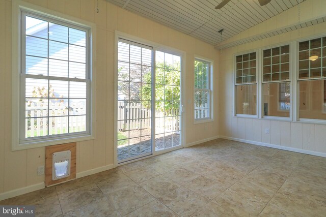 doorway to outside featuring ceiling fan and lofted ceiling