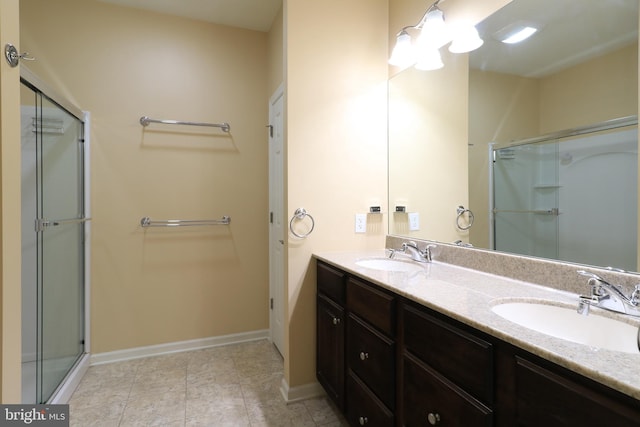 bathroom featuring vanity and an enclosed shower