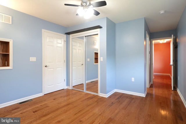 unfurnished bedroom featuring a closet, ceiling fan, and hardwood / wood-style floors