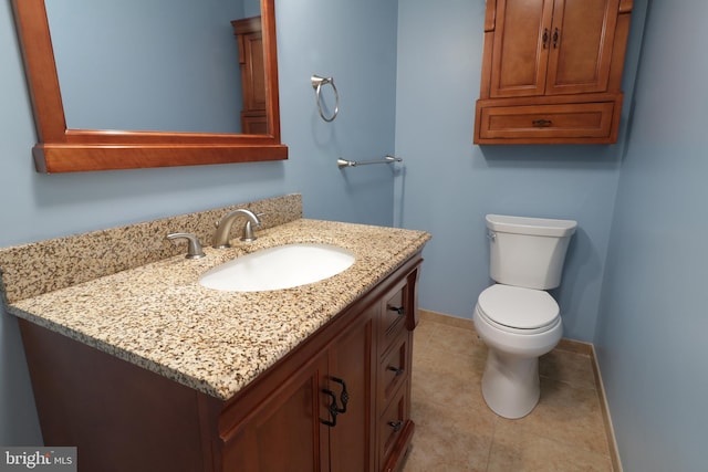 bathroom with tile patterned floors, vanity, and toilet