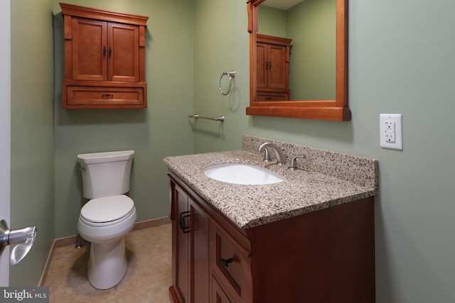 bathroom featuring tile patterned flooring, vanity, and toilet