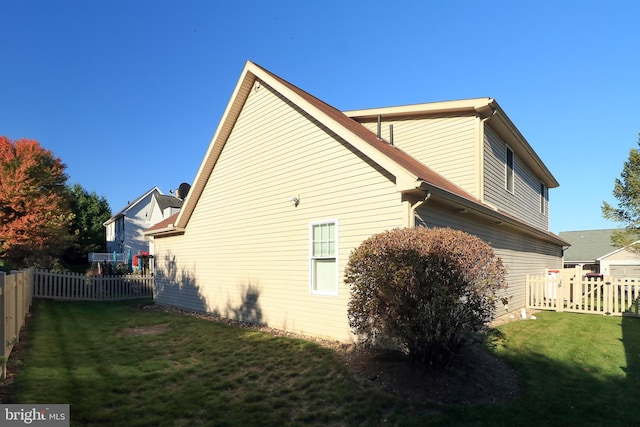 view of side of property with a yard