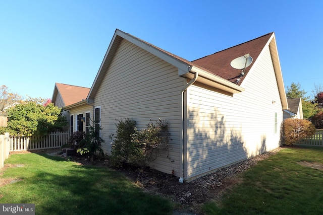 view of side of property with a yard