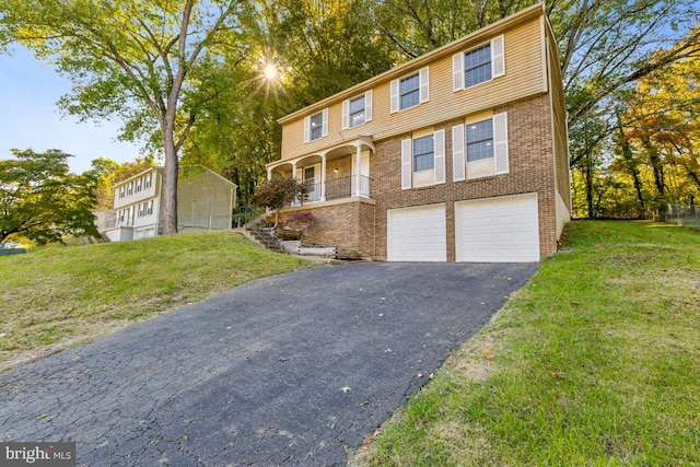 view of front of property featuring a front lawn and a garage