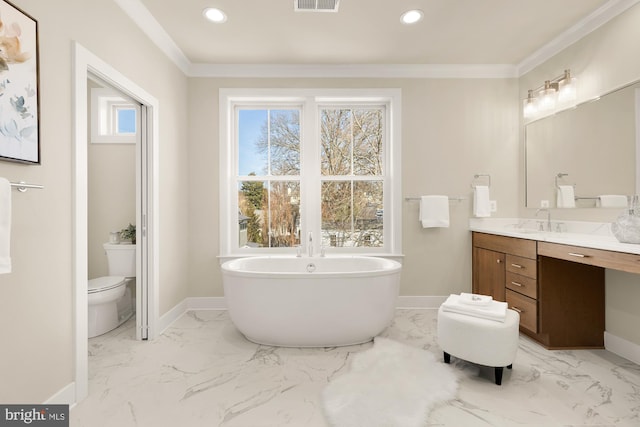 bathroom with toilet, ornamental molding, vanity, and a bathtub