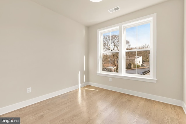 unfurnished room with light hardwood / wood-style floors