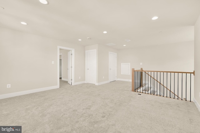 unfurnished room with light colored carpet