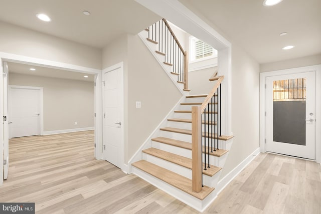 staircase with hardwood / wood-style flooring