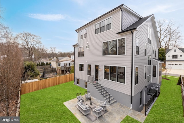 back of property featuring a patio area and a yard