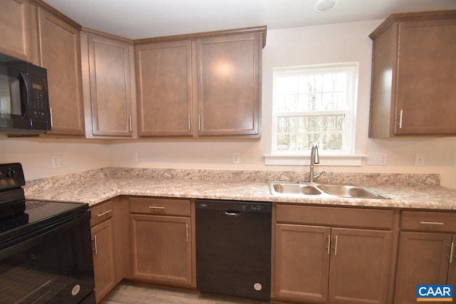 kitchen featuring black appliances and sink