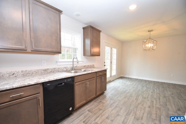 kitchen featuring black dishwasher, light hardwood / wood-style flooring, sink, a notable chandelier, and decorative light fixtures