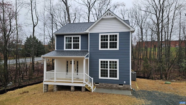 view of front of house with covered porch and central AC unit