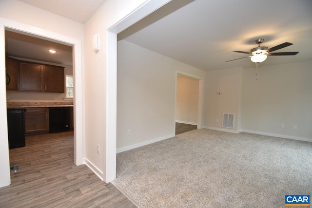 spare room featuring light carpet and ceiling fan