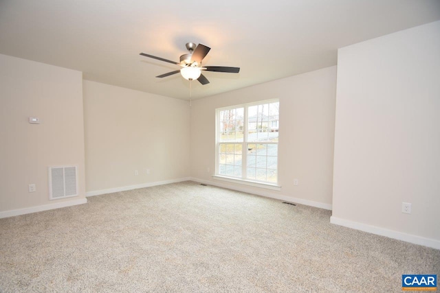 empty room featuring light colored carpet and ceiling fan