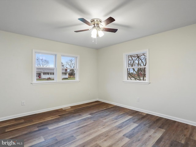 unfurnished room with dark hardwood / wood-style flooring, ceiling fan, and a healthy amount of sunlight