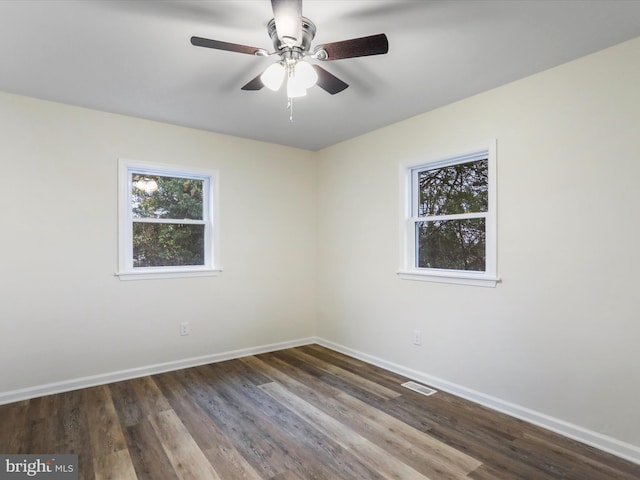 unfurnished room featuring ceiling fan and dark wood-type flooring