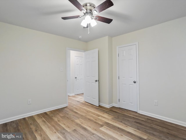 unfurnished bedroom with ceiling fan and light wood-type flooring