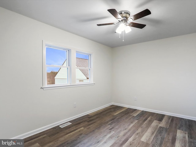 spare room featuring ceiling fan and dark hardwood / wood-style flooring