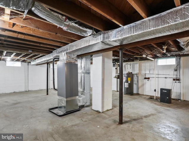 basement with electric water heater and heating unit