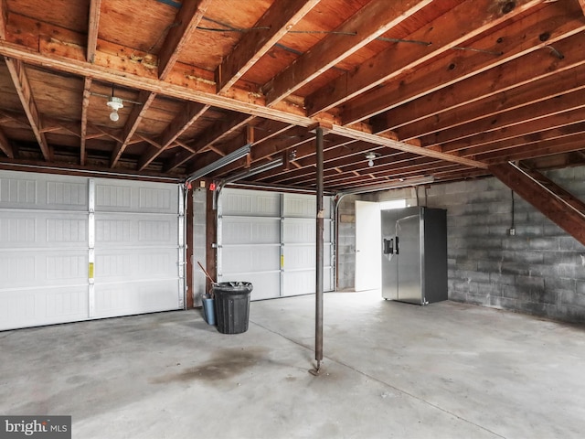 garage with stainless steel fridge