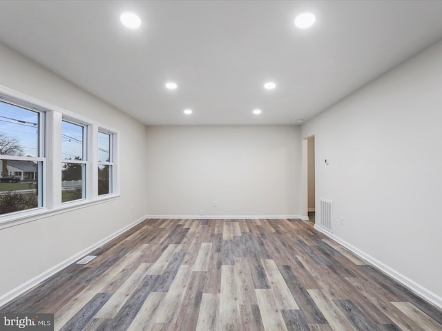 unfurnished room with hardwood / wood-style floors