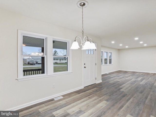 entryway featuring hardwood / wood-style floors and an inviting chandelier