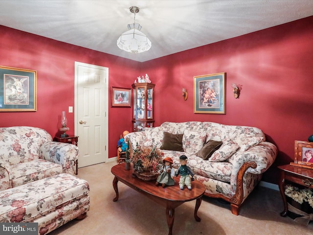 living room with light colored carpet and a notable chandelier