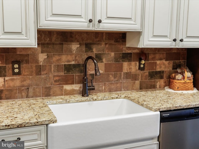 details with dishwasher, white cabinetry, sink, and light stone counters