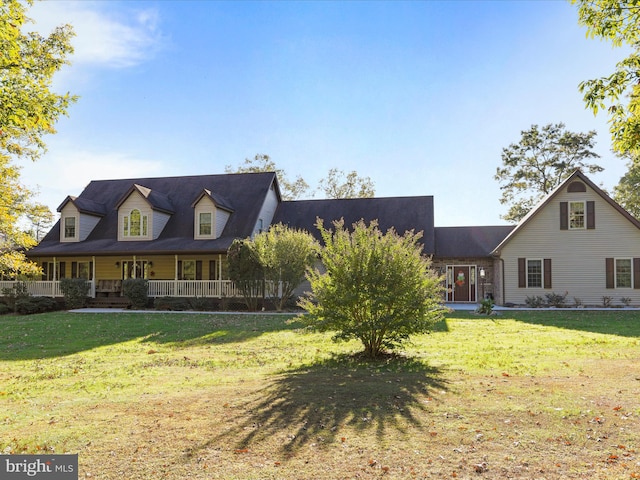 new england style home with covered porch and a front yard